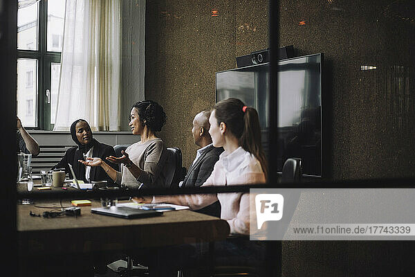 Female entrepreneur discussing strategy with colleagues in meeting room