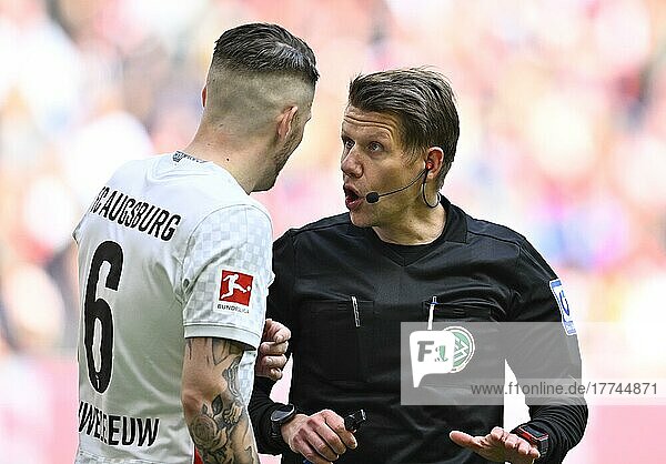 Referee Patrick Ittrich in conversation with Jeffrey Gouweleeuw FC Augsburg FCA (06)  Allianz Arena  Munich  Bavaria  Germany  Europe
