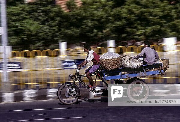 People journeying on a tricycle on the beach road in Chennai  Tamil Nadu  India  Asia