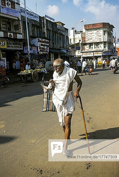 An old man walking with stick in chennai  Tamil Nadu  India  Asia