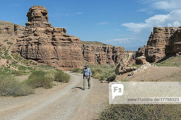 Mann  der auf der Straße im Sharyn-Canyon-Nationalpark und im Tal der Schlösser spazieren geht  Tien-Shan-Gebirge  Kasachstan  Asien