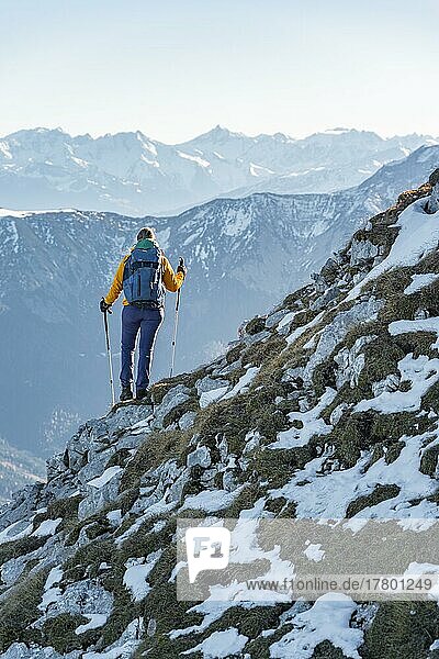 Climber on a ledge  snow-covered mountains  hiking to the Guffert in winter  Brandenberg Alps  Tyrol  Austria  Europe