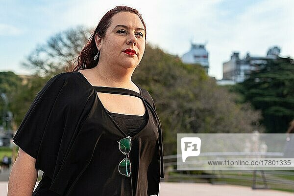 Portrait of a plus-size woman walking confidently and energetically. Woman power. Copy space