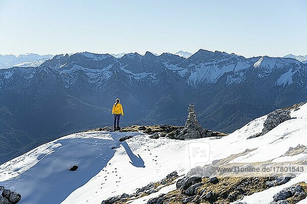 Mountaineer looks over snow-covered mountains  hiking to the Guffert  Brandenberg Alps  Tyrol  Austria  Europe