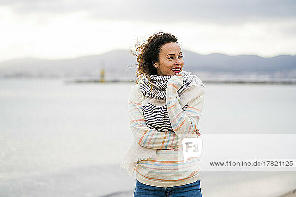 Mature woman wearing scarf at beach