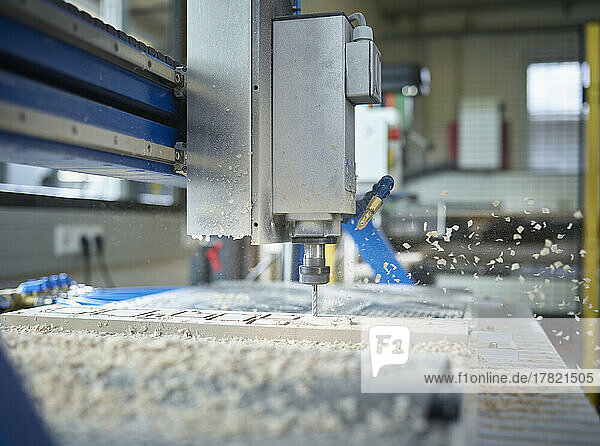 CNC machine cutting wood in factory