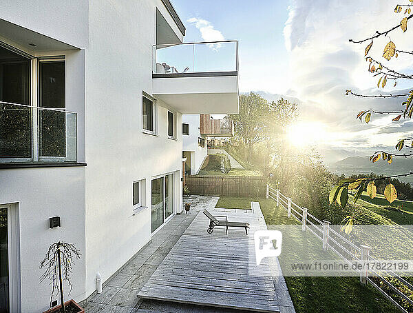 Austria  Tyrol  Exterior of modern hilltop house with sun setting in background