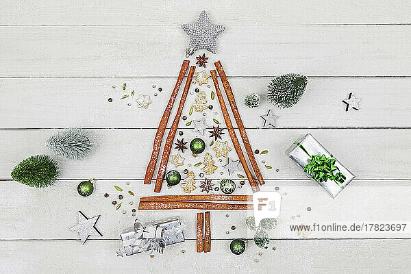 Studio shot of Christmas tree shape made of various spices  cookies and Christmas ornaments