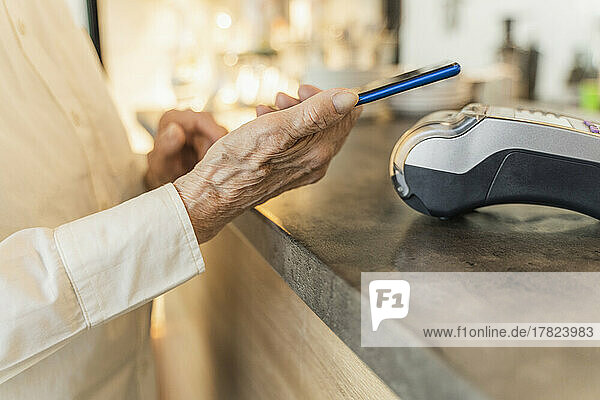 Senior woman making payment through smart phone