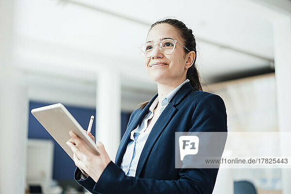 Businesswoman with tablet PC at work place