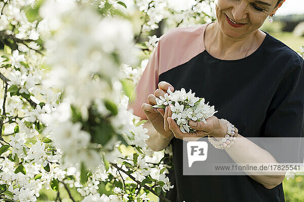 Smiling woman holding white flowers
