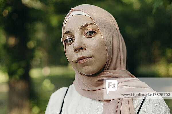 Young woman with hijab in public park