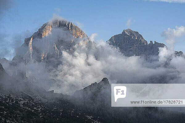 Tofane at sunrise with low clouds and a blue sky  Dolomites  Veneto  Italy  Europe