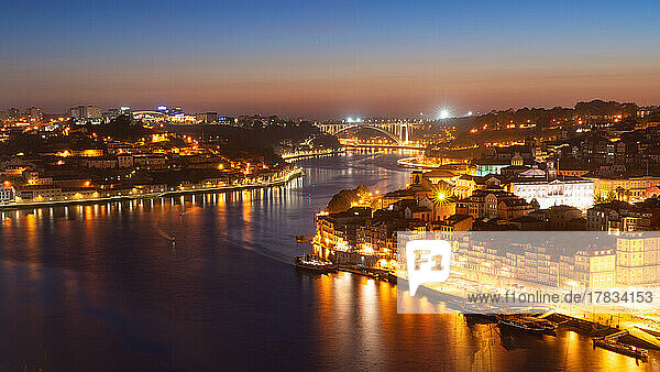 Skyline of the historic city of Porto at night with the bridge Ponte de Arrabida in the background  Oporto  Portugal  Europe