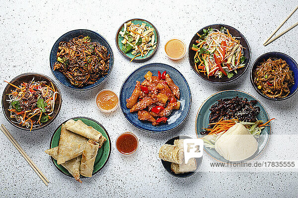 Set of Chinese dishes on white table