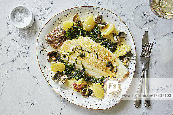 Lemon sole with clams  potatoes and green vegetables