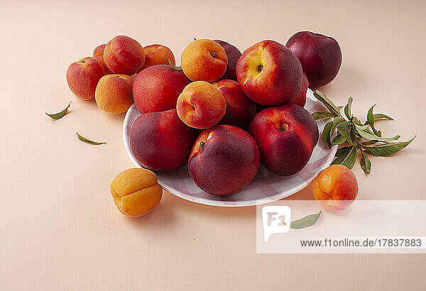 Peaches and apricots on the background
