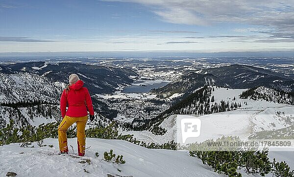 View of Schliersee  ski tourer at the summit of Jägerkamp in winter  Bavaria  Germany  Europe