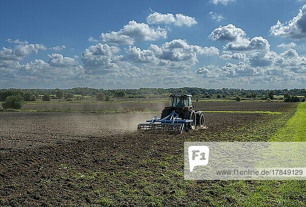 Agriculture  tractor ploughing the field  Berlin  Germany  Europe