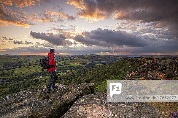A male walker standing on Curbar Edge at sunset  Peak District  Derbyshire  England  United Kingdom  Europe