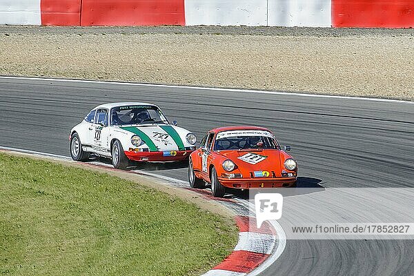 Two historic racing cars Porsche 911 close together in curve at car race for classic cars Youngtimer Classic Cars 24-hour race 24h race  Nürburgring race track  Nürburg  Eifel  Rhineland-Palatinate  Germany  Europe