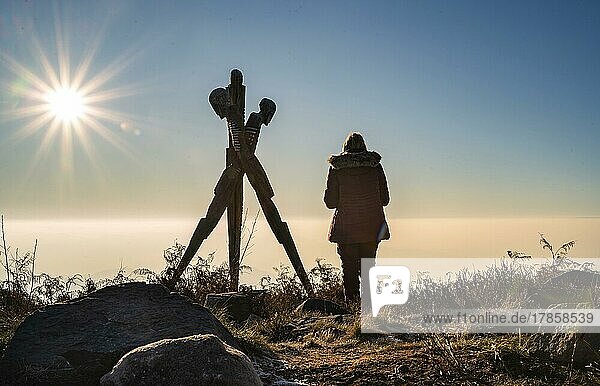 Woman standing at the Lothar Monument above a foggy Black Forest  Nordrach  Germany  Europe