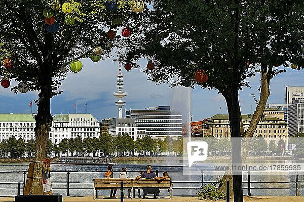 The trees on Ballindamm by the Inner Alster Lake are decorated with lanterns at Hamburg's summer gardens  Hamburg  Germany  Europe