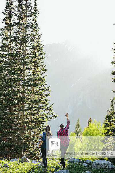 Couple holding hands and walking on rocks in Utah Big Cottonwood