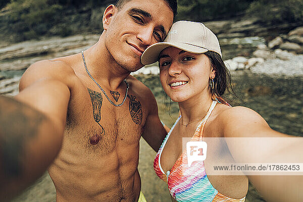 Couple taking selfie while bathing at river. Cañon de Añisclo  Huesca.