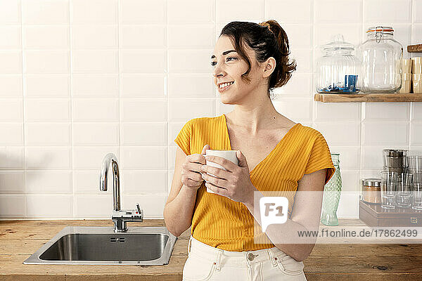 Young woman enjoying coffee at home