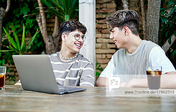 Gay Couple influencers Recording Video Of Themselves Using laptop
