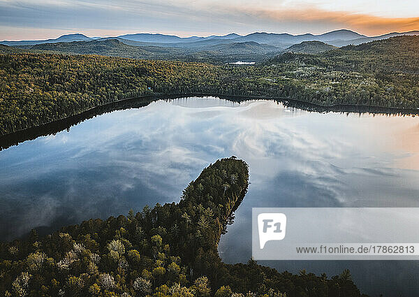 Evening sky and mountains reflected in aerial image of Jim Pond  Maine