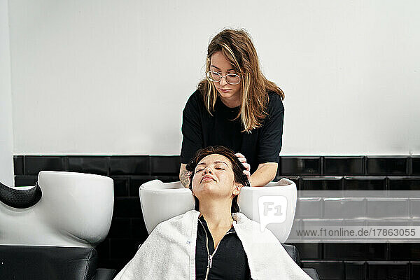 pretty Female hairdresser while working.