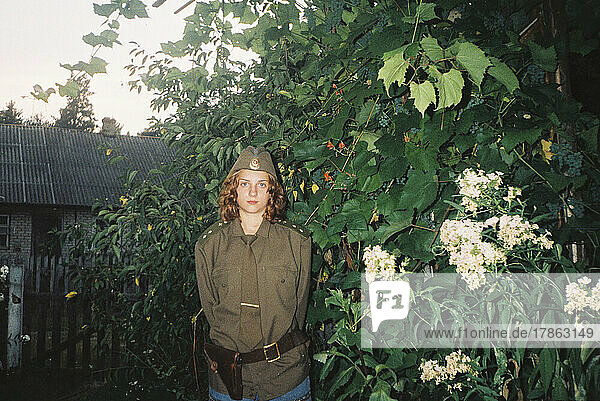 teenage woman in military uniform in nature
