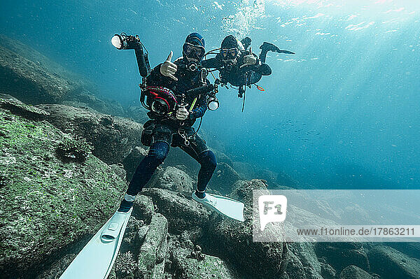 divers in the tropical waters of the Andaman Sea in Thailand