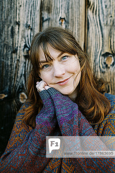 portrait of a smiling woman in a handmade knit sweater