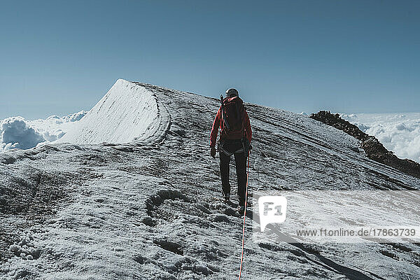 Shot of female Mountaineer ascending last meters towards summit