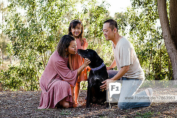 Family of Three Posing with Dog in Park at Sunset in San Diego