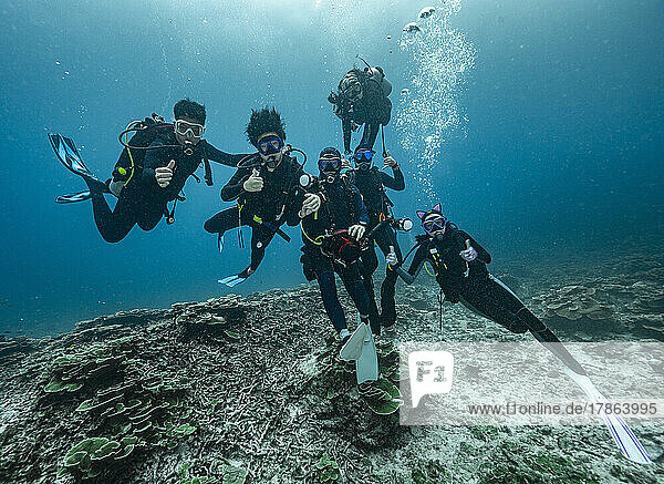 Divers emerging into the tropical waters of the Andaman Sea