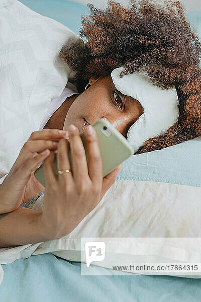 woman in bed with phone