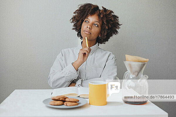 A thoughtful woman and planning a day at breakfast.