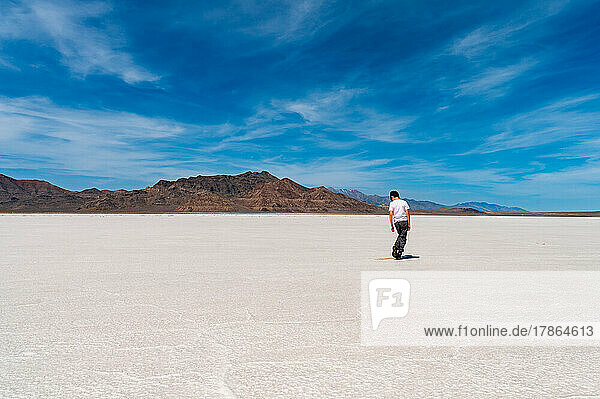 a boy standing on the salt flats on a bright sunny day in Utah