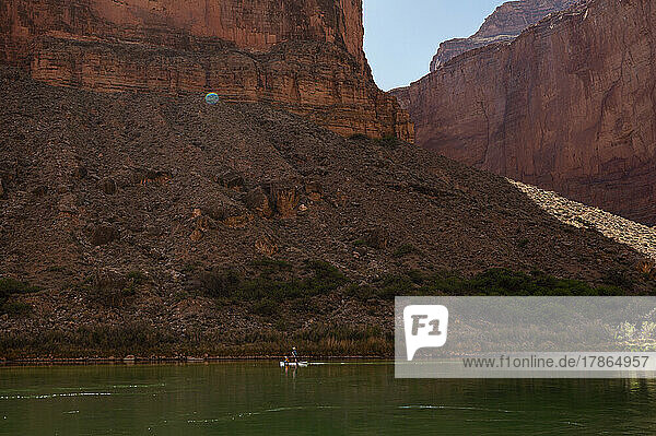 A woman and her daughter paddling a SUP in the Grand Canyon
