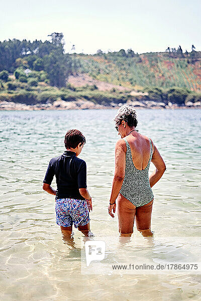 Mom and son bathing on the beach