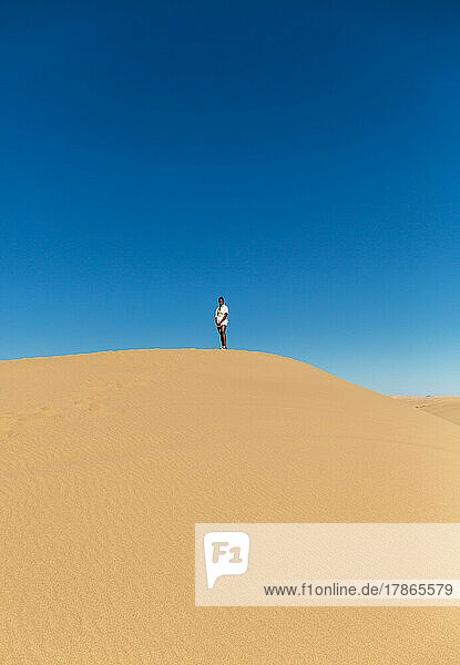 Black girl standing on a dune