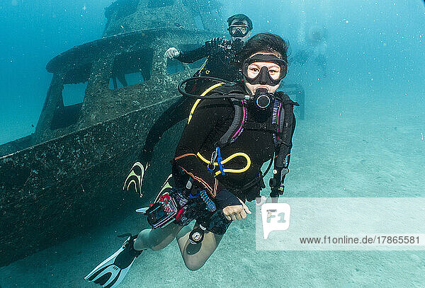 divers exploring a wreck on a dive around Phuket