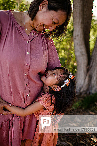 Daughter Hugging Mom in Park in San Diego