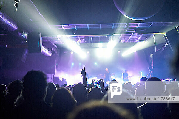 Sillhouettes Of Concert Crowd In Front Of Bright Stage Lights