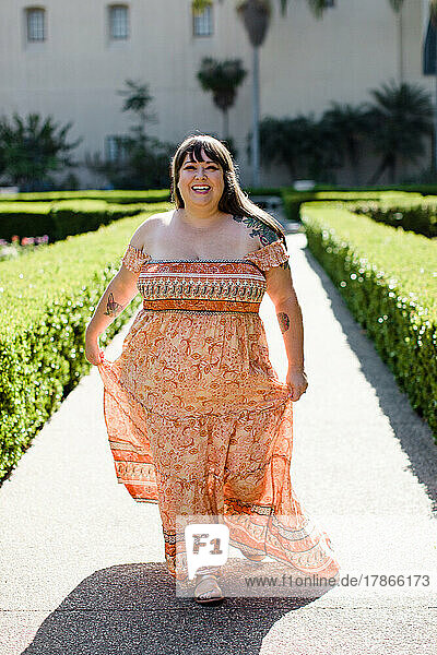 Plus Size Model Wearing Long Orange Dress in San Diego