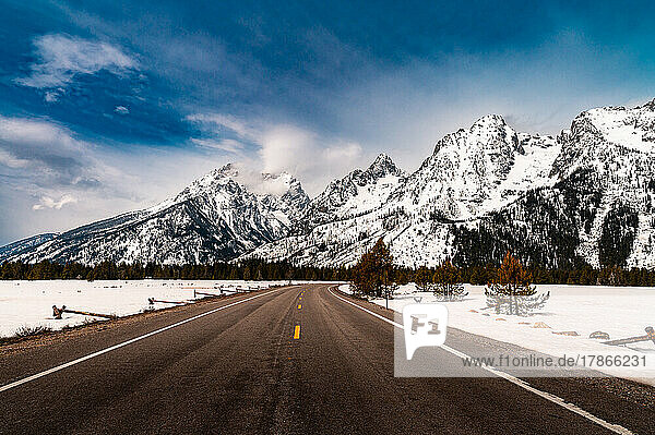 a road leading into the grand Teton mountain range in Wyoming